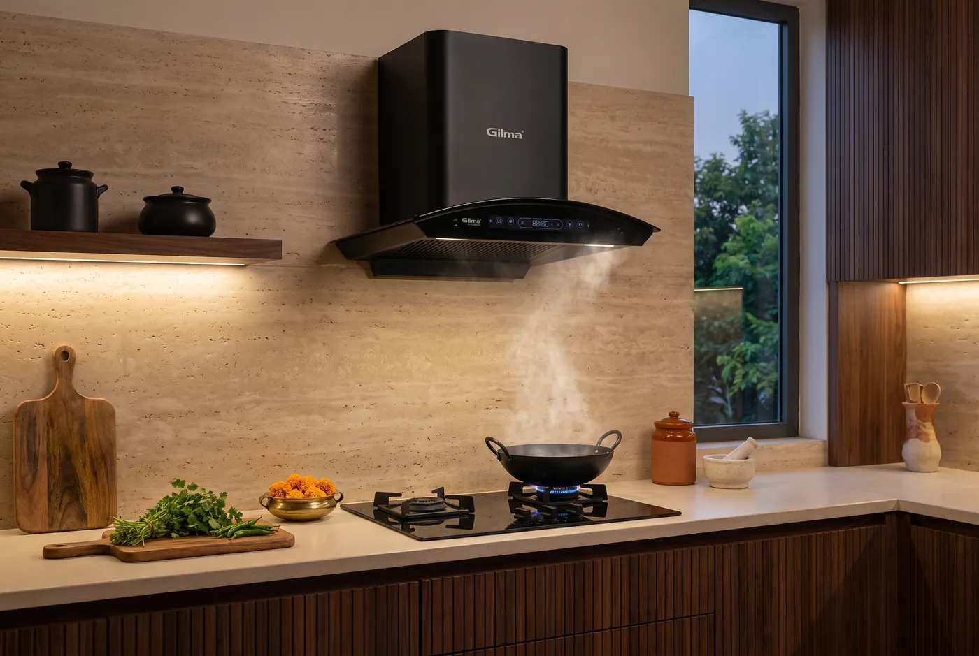 A Gilma chimney above a hob in a modern kitchen